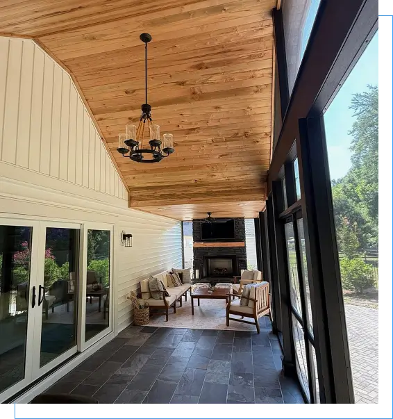 Covered patio with seating and fireplace view.
