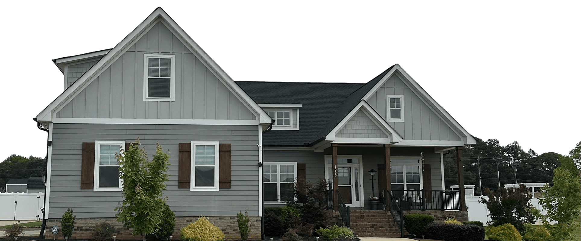 Gray house with gable roof, front porch.