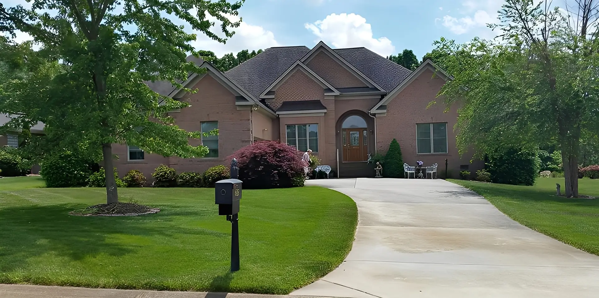 Brick house with landscaped front yard.
